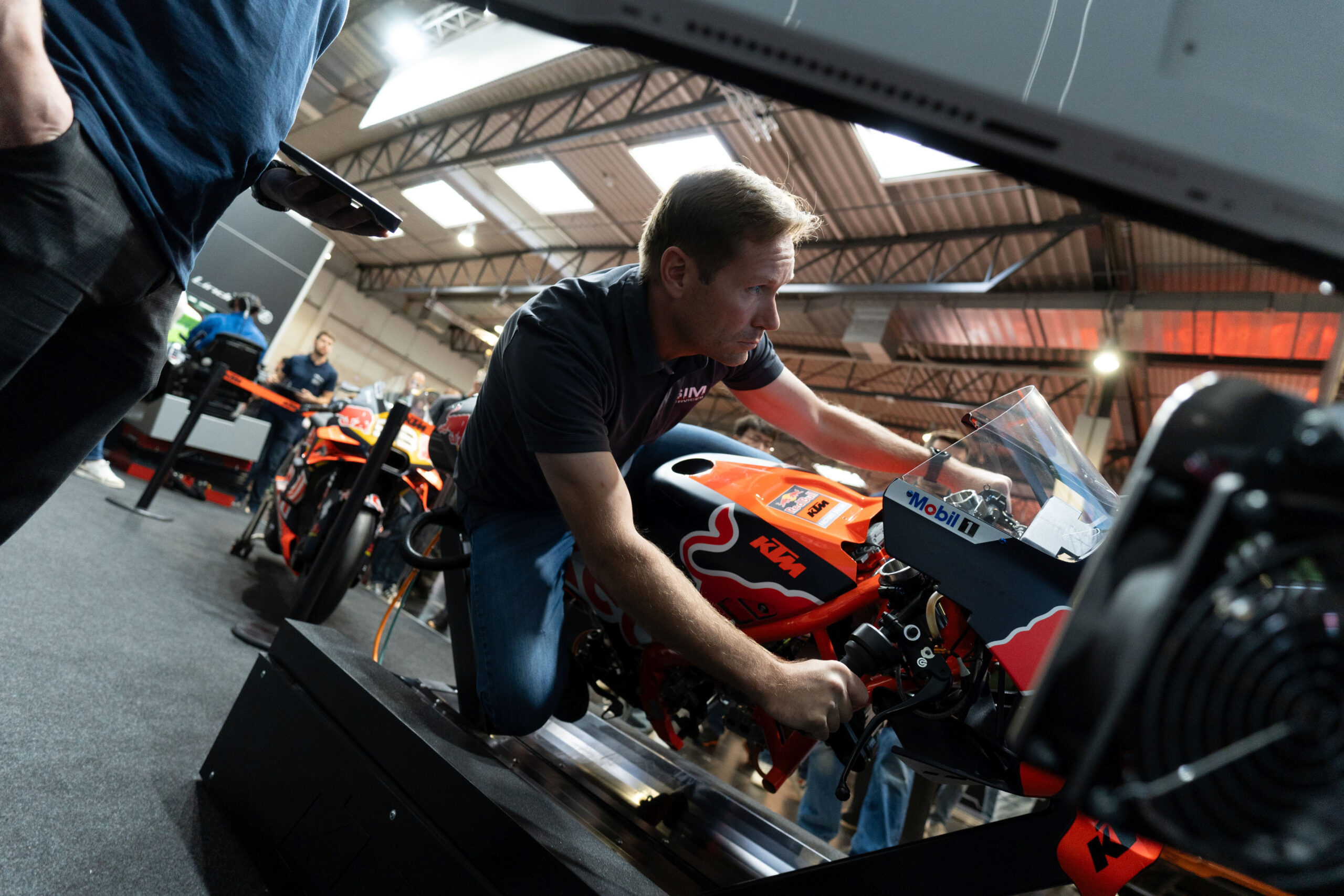 A person on a motorcycle-shaped racing sim rig.