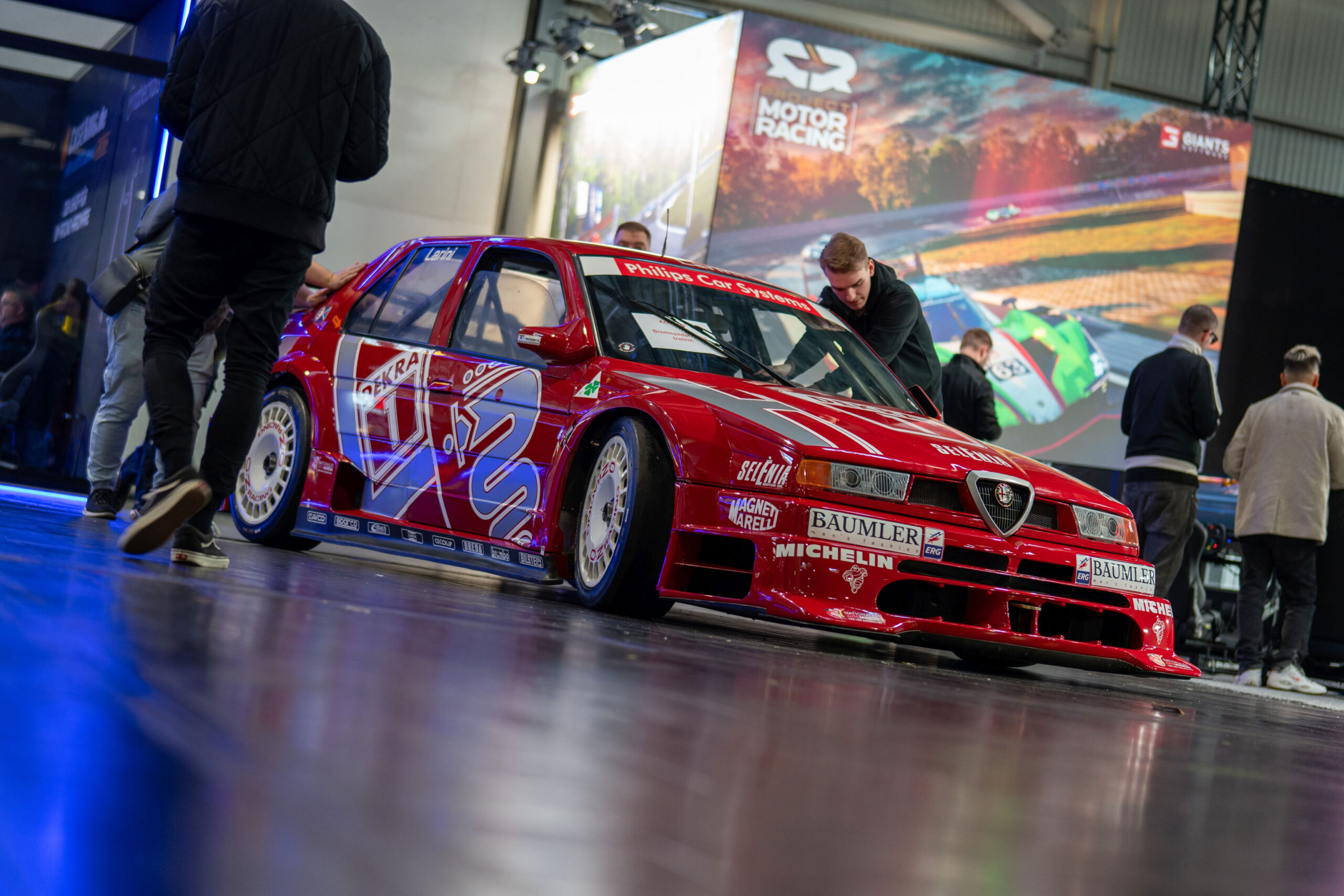 An Alpha Romeo 155 V6 TI race car on the convention floor.